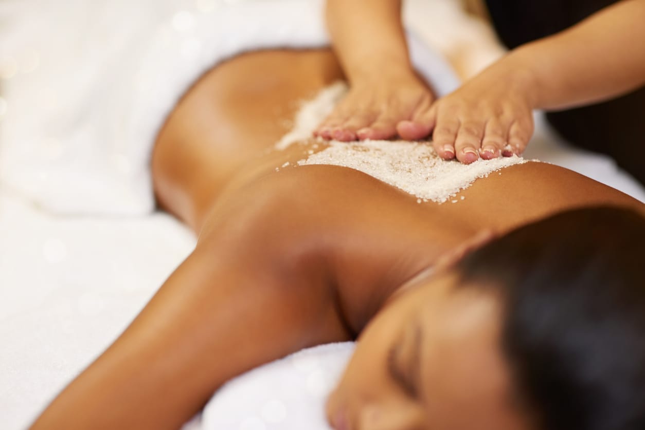 Women enjoying a luxurious spa treatment during a Bali wellness retreat, featuring a relaxing body scrub for rejuvenation and health.