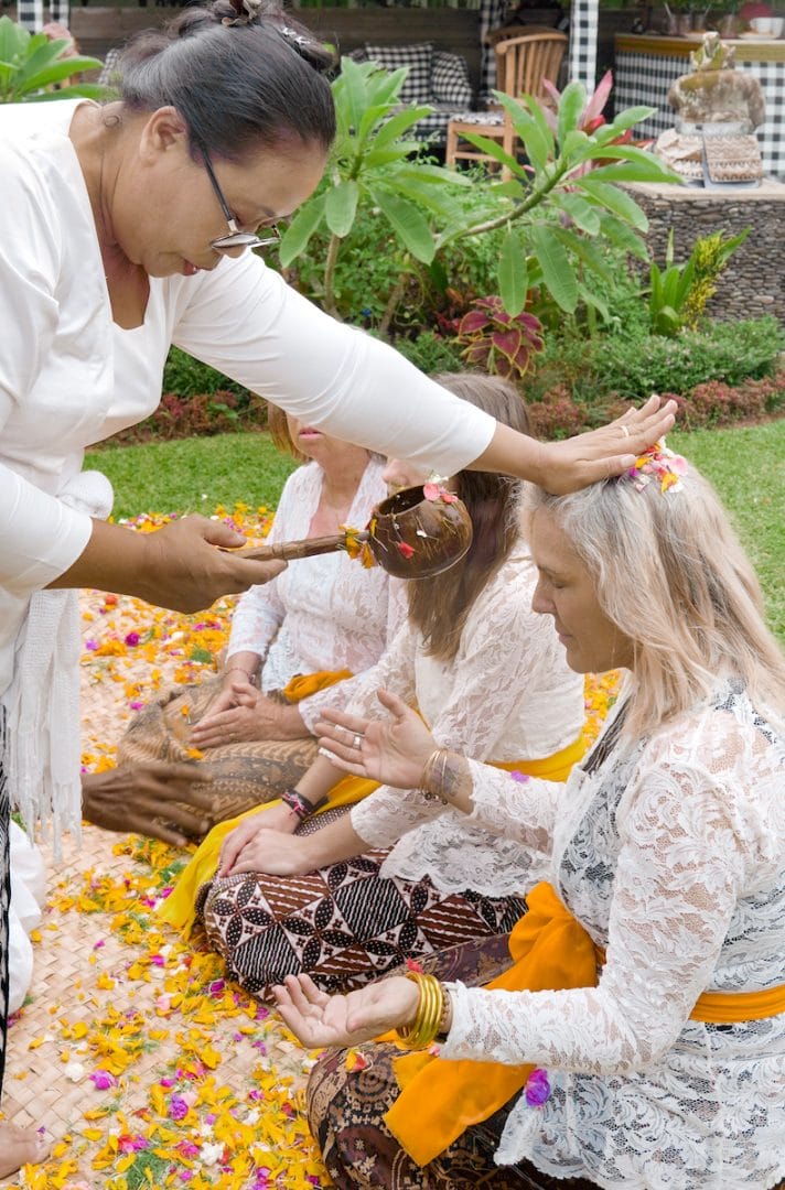 A peaceful moment during a healing retreat for women in Bali, with serene surroundings and a group of women practicing yoga and mindfulness.